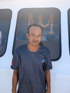 Gorn, the chief engineer of MV Raga, standing confidently on the boat deck.
