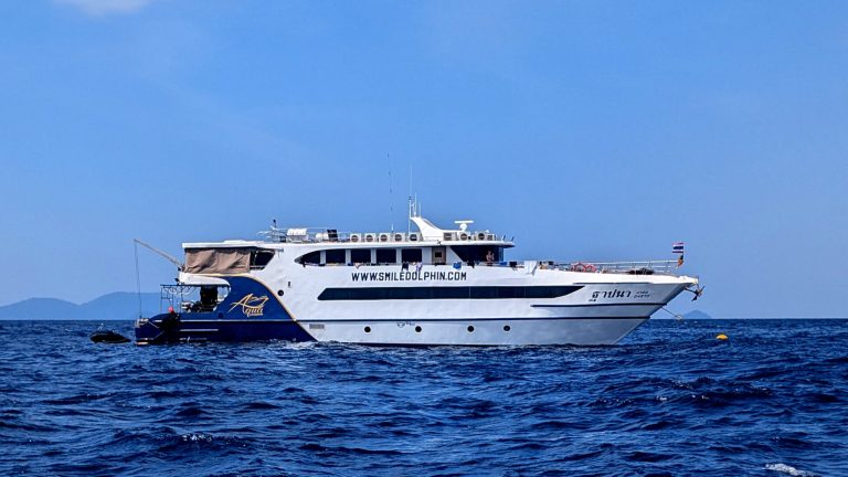 MV Aqua liveaboard (officially registered as MV Tapana) cruising the Andaman Sea on a calm day.